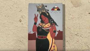 A painting of a native american woman holding a peace sign.
