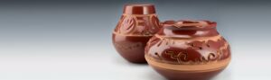 Two brown vases on a gray background.