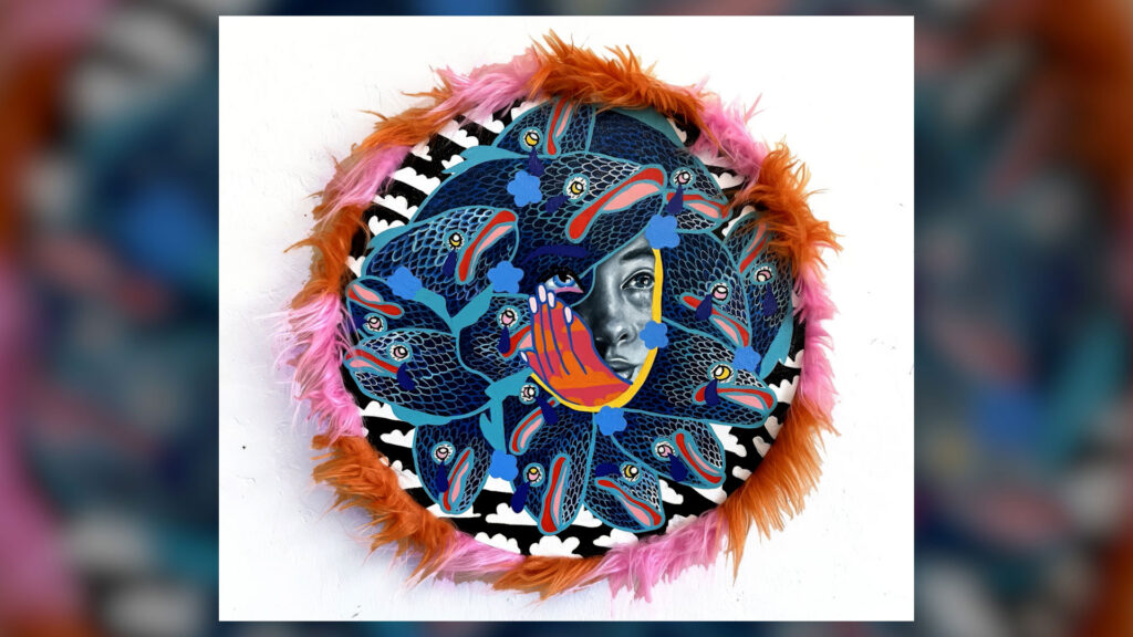 A circular artwork features a woman's face surrounded by vibrant, abstract fish and feathered edges in orange and pink tones.