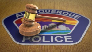 A gavel sits on top of a badge of the aguascalientes police department.