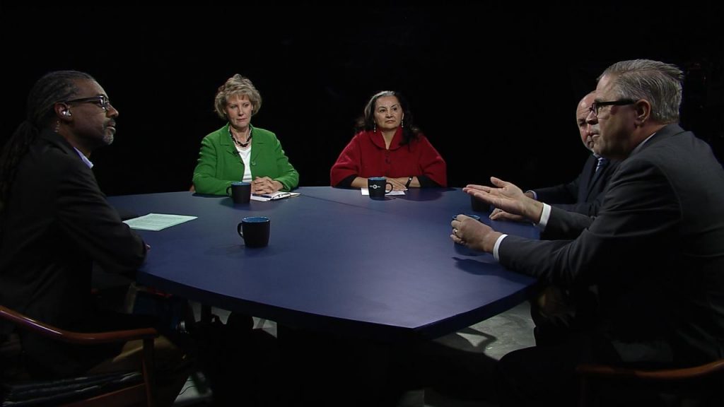 A group of people sitting around a round table.