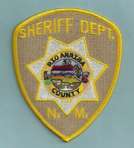 A sheriff department patch with the word sheriff on it.