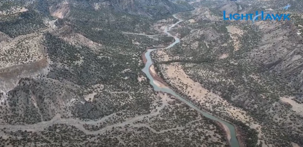 An aerial view of a water-filled river in a canyon.