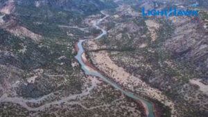 Aerial view of a winding river through a mountainous landscape, with the word "LightHawk" in blue text at the top right corner.